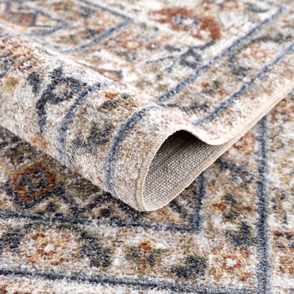 Erez Flat Pile Washable Rug by Boutique Rugs; beige gray blue patterned pile with folded edge on Tampa Home & Garden Store