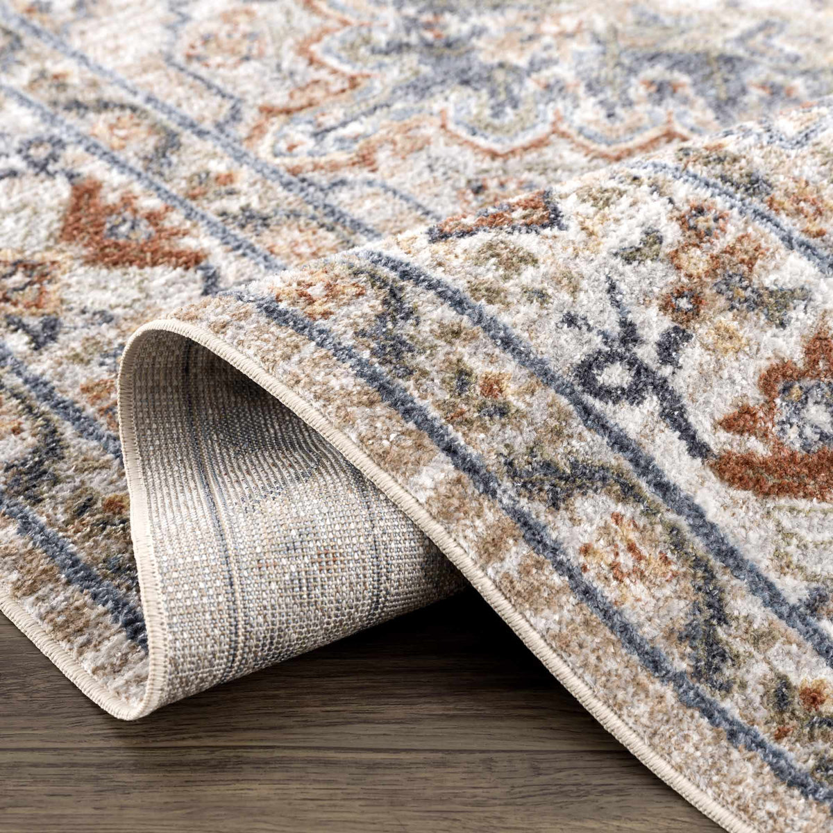 Erez Flat Pile Washable Rug by Boutique Rugs in gray blue beige rust tones, rolled edge on Tampa Home & Garden Store