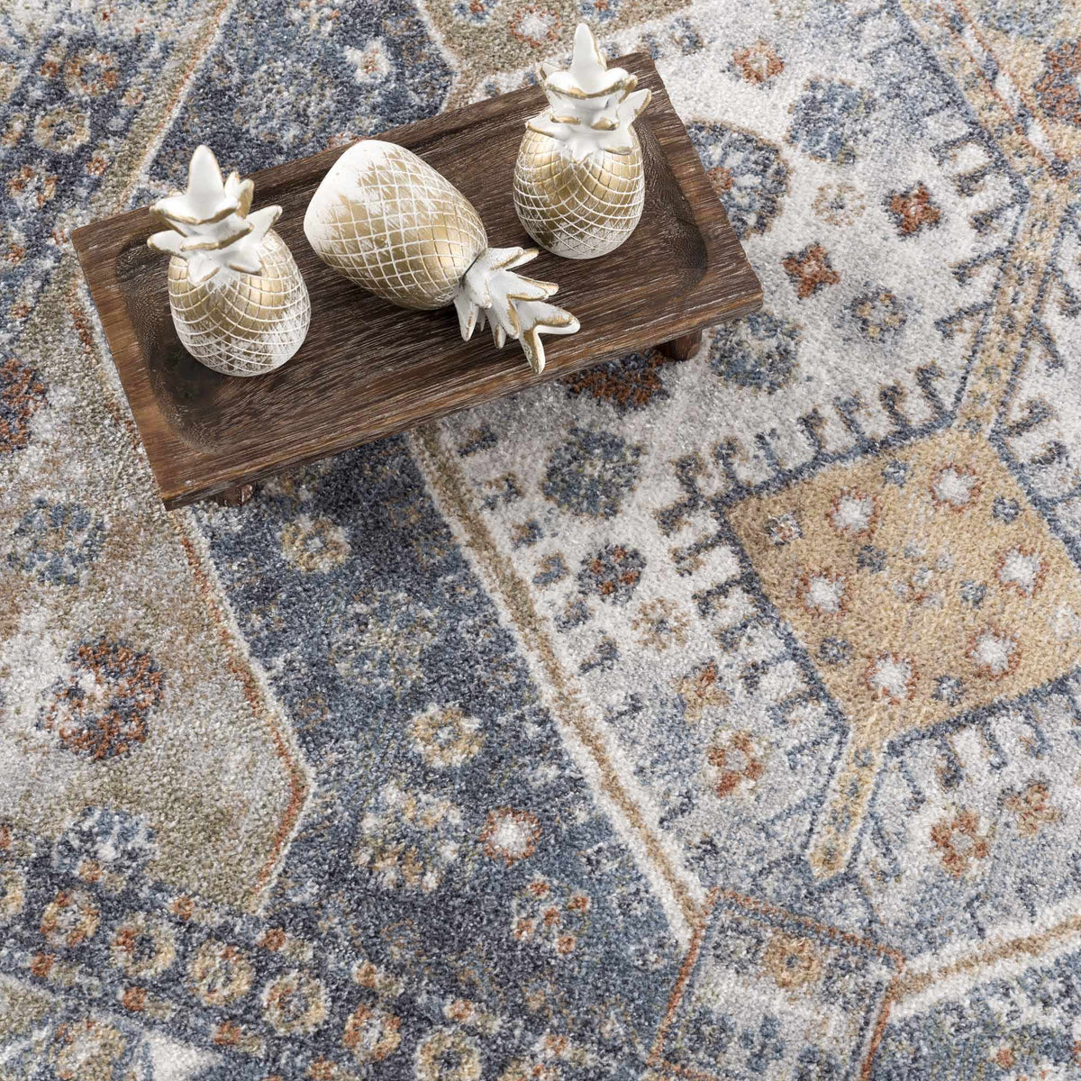 Afya Boutique washable rug with blue beige rust tones and a distressed pattern on Tampa Home & Garden Store