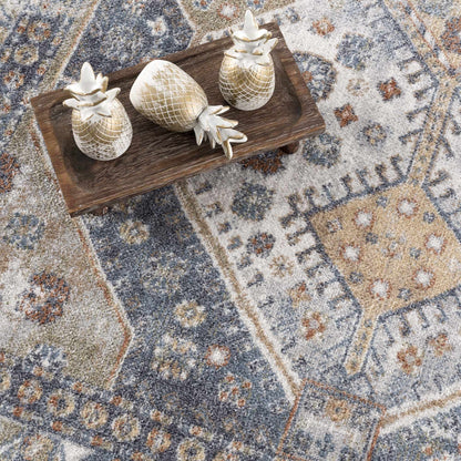 Afya Boutique washable rug with blue beige rust tones and a distressed pattern on Tampa Home & Garden Store