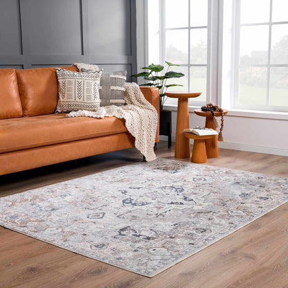 Dobry Boutique Washable Rug with blue-gray distressed pattern under a tan leather sofa on Tampa Home & Garden Store