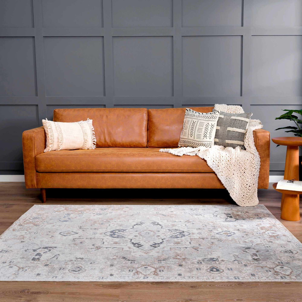 Dobry Boutique Washable Rug in gray with subtle medallion pattern under a tan leather sofa on Tampa Home & Garden Store