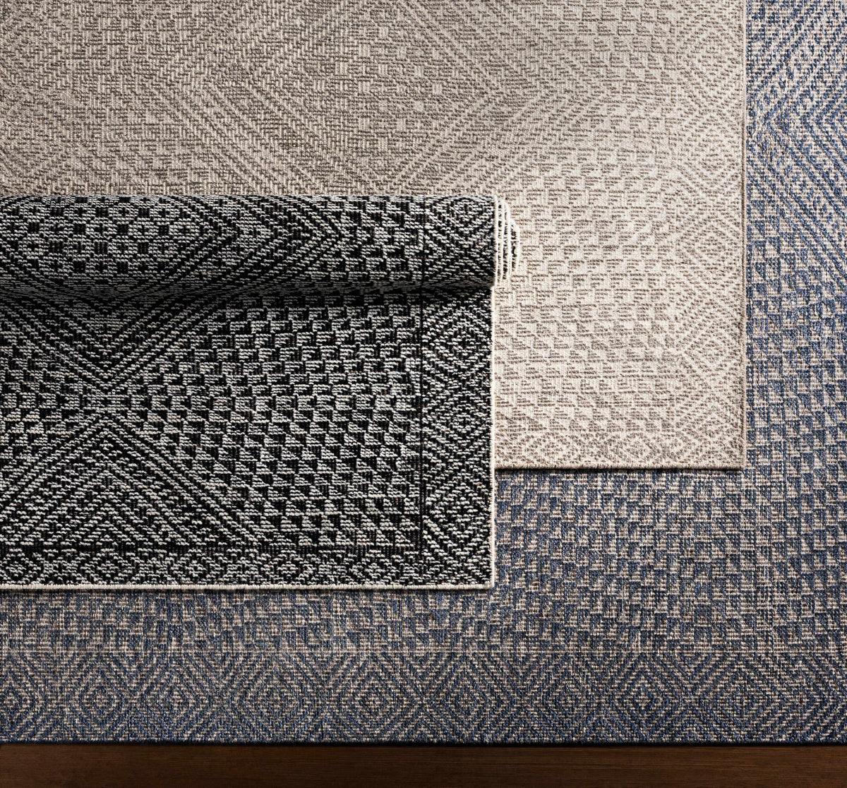 Moyne Area Rug patchwork display in beige taupe and blue tones Boutique Rugs on Tampa Home & Garden Store