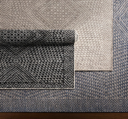 Moyne Area Rug patchwork display in beige taupe and blue tones Boutique Rugs on Tampa Home & Garden Store