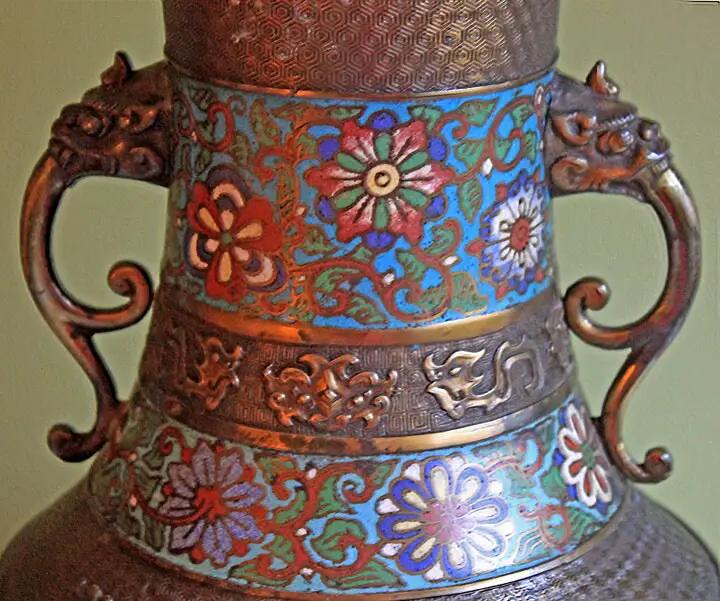 Decorative metal vase with multicolor enamel floral pattern and ornate dragon-handled sides on Tampa Home & Garden Store