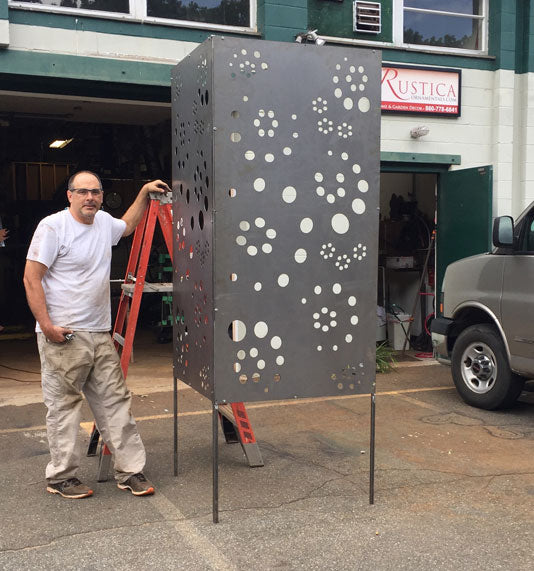 Large metal privacy screen with circular cutouts on slender legs, Rustica Ornamentals on Tampa Home & Garden Store