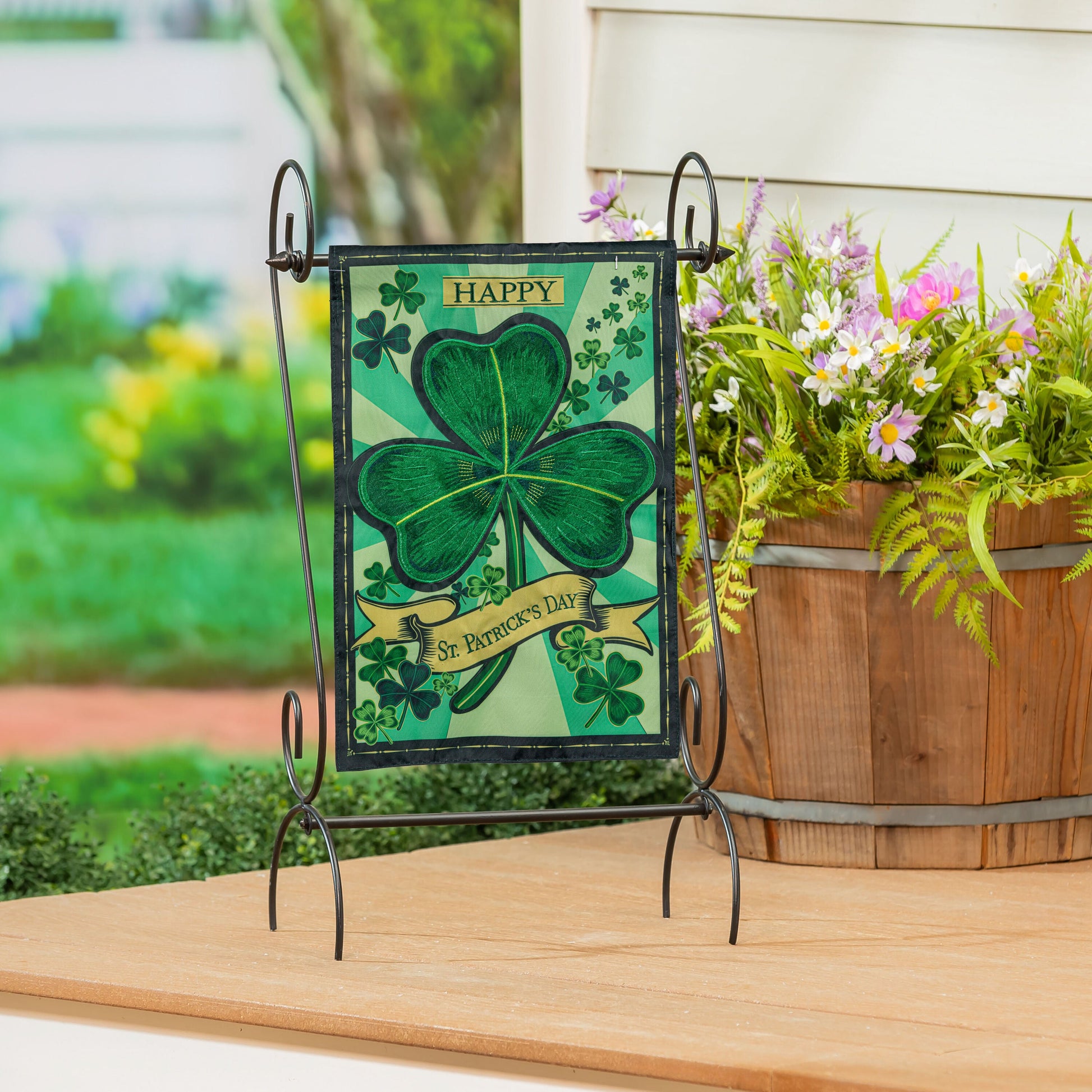 St Patrick's Day Shamrock Applique Garden Flag on black metal stand with bold green clover on Tampa Home & Garden Store