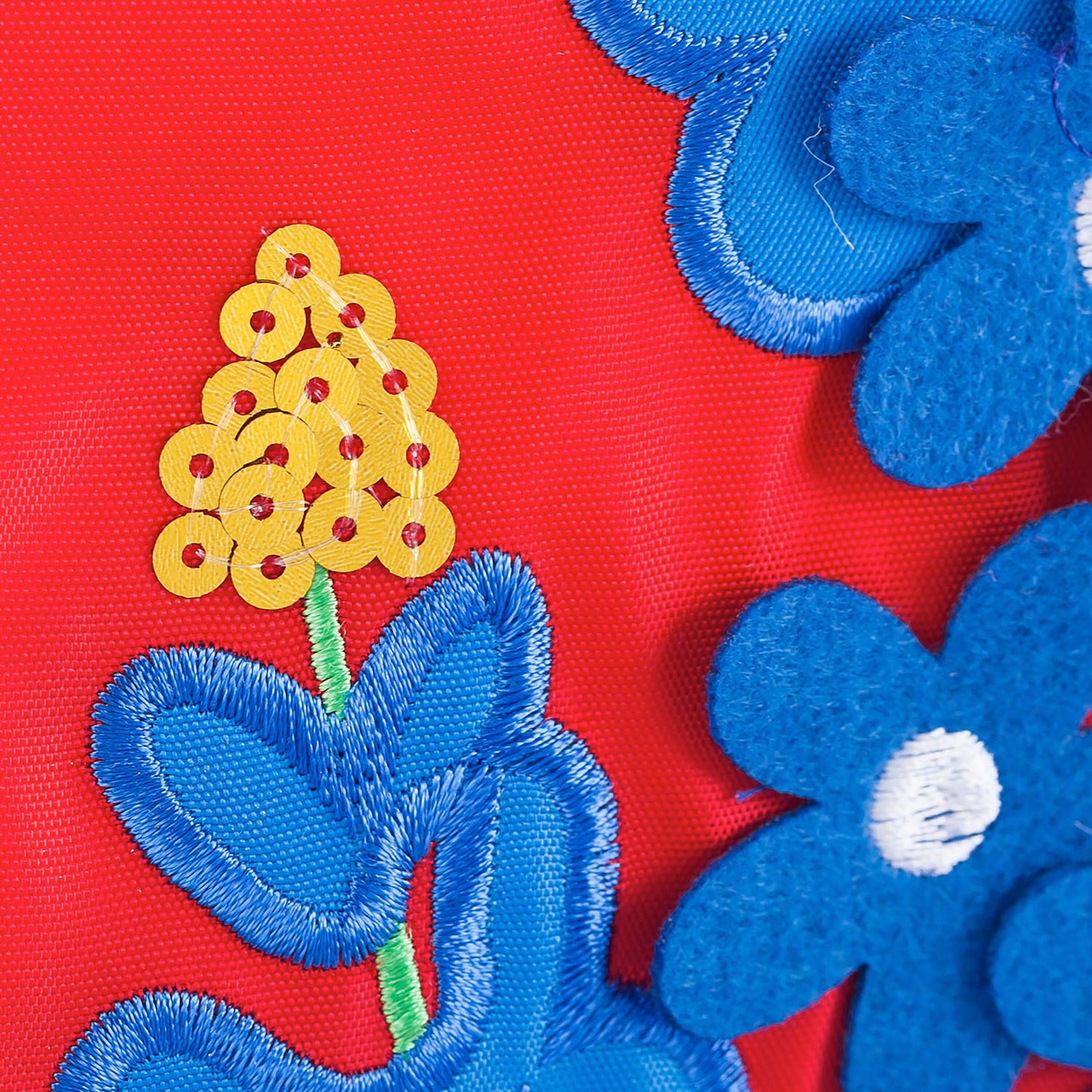 Texas bluebonnet applique flag close-up on red fabric with blue fringe and yellow sequins on Tampa Home & Garden Store