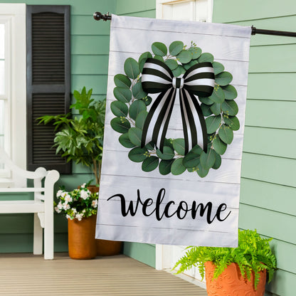Eucalyptus leaves wreath burlap flag with black and white striped bow on light wood background on Tampa Home & Garden Store