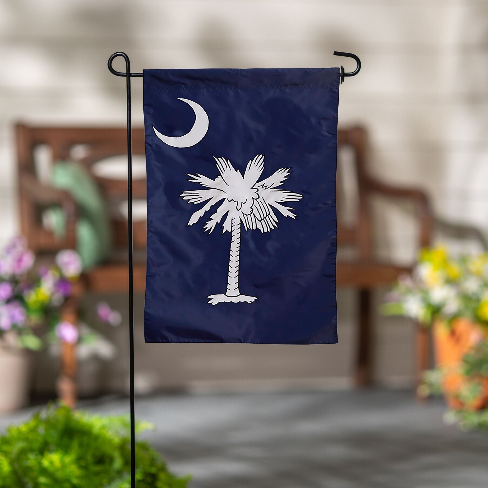 South Carolina applique flag navy blue featuring palmetto tree and crescent moon on display on Tampa Home & Garden Store