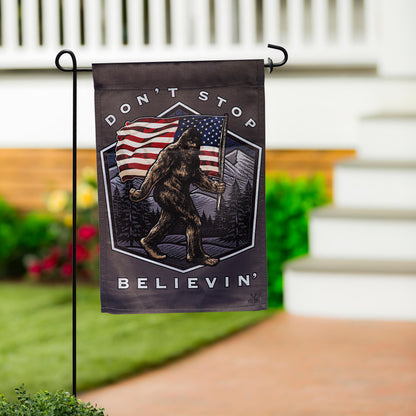 Don't Stop Believin' Suede Garden Flag with bear holding American flag on black metal stand on Tampa Home & Garden Store