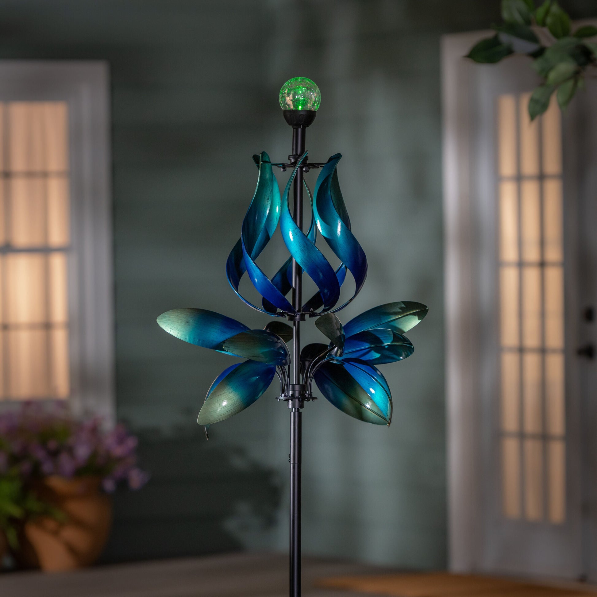 Seaside Retreat Wind Spinner solar blue teal gradient with glowing green LED globe at top on Tampa Home & Garden Store