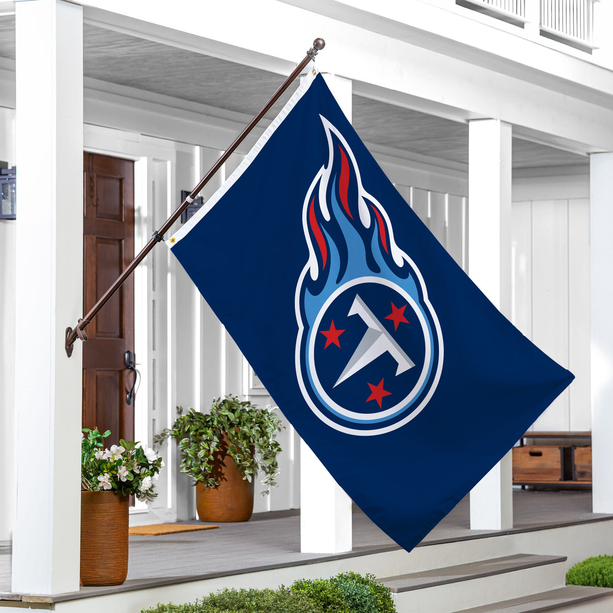 Tennessee Titans flag 3x5 ft, single-sided sublimated flag with blue flame emblem, two grommets on a brown flagpole on Tampa Home & Garden Store