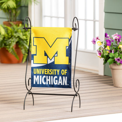 University of Michigan burlap flag in maize and blue on a black metal stand on Tampa Home & Garden Store