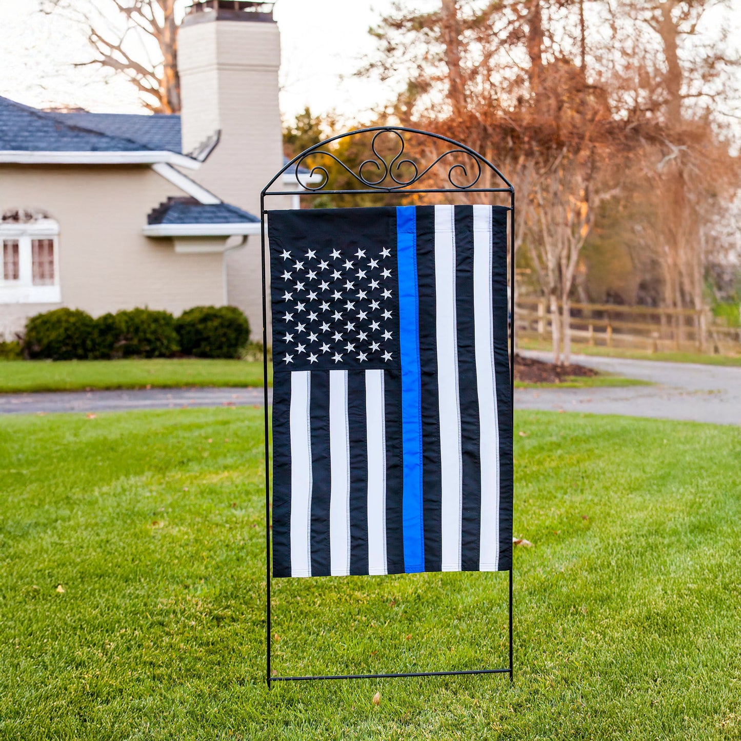Thin Blue Line House Applique Flag with blue stripe on wrought iron stand in yard on Tampa Home & Garden Store