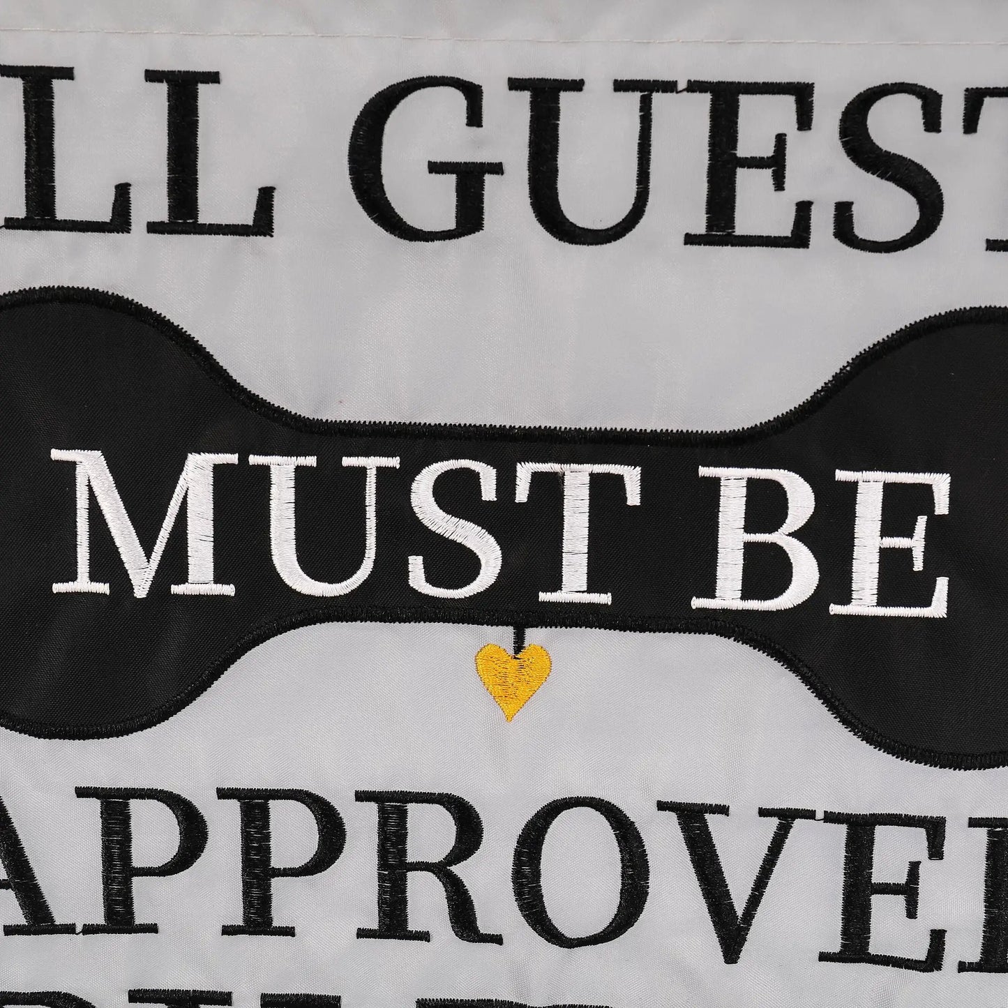 Approved by the Dog applique flag with black lettering on white fabric and a yellow heart on Tampa Home & Garden Store