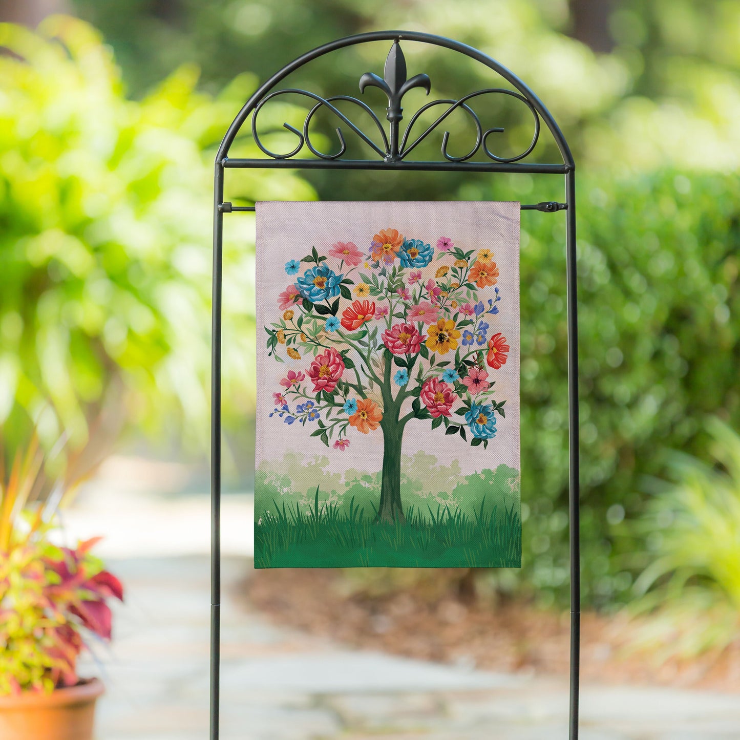 Blooming Tree of Life Burlap Garden Flag on black metal arch stand with floral tree on Tampa Home & Garden Store
