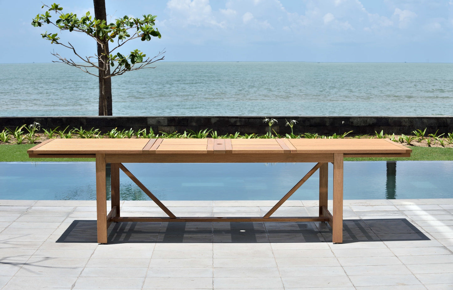 Leyland Table and Nassau White Armchairs Dining Set outdoor wooden table by pool with ocean view on Tampa Home & Garden Store