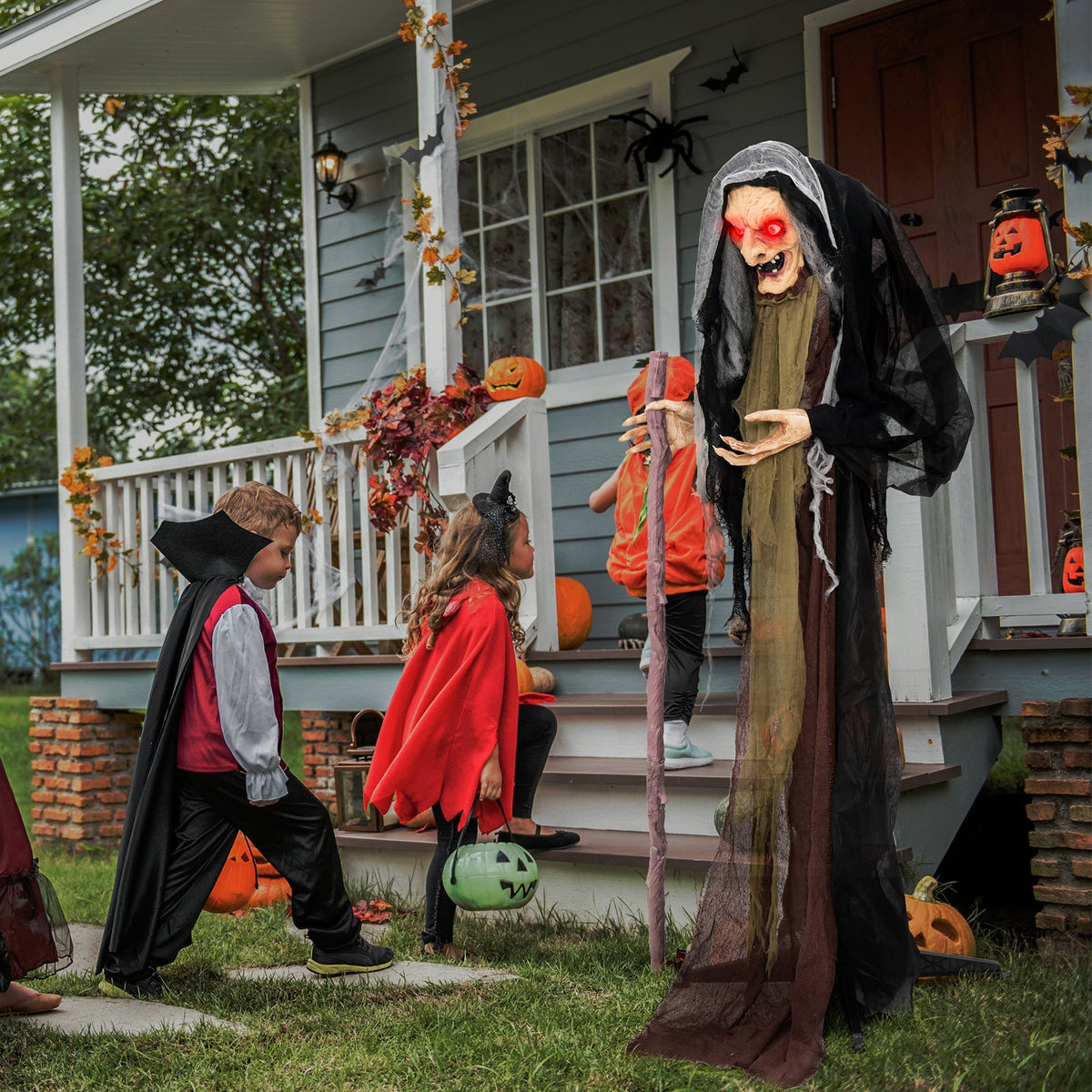 Life Size Animatronic Witch with Pre-Recorded Phrases cardboard cutout on porch with pumpkins on Tampa Home & Garden Store