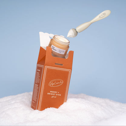 UpCircle Merry + Bright Eyes Gift Set eye cream in orange box with white spatula blue sky on Tampa Home & Garden Store