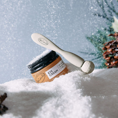 Eye cream by UpCircle in amber jar with white lid and spatula on snowy background on Tampa Home & Garden Store
