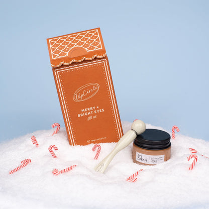 UpCircle Merry + Bright Eyes Gift Set orange packaging with eye cream jar on snow on Tampa Home & Garden Store