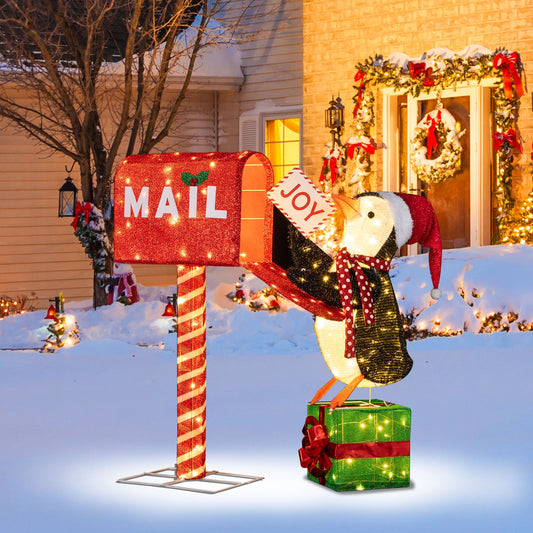 Lighted mailbox and penguin 3D holiday decor; red glitter mailbox with JOY sign in yard on Tampa Home & Garden Store
