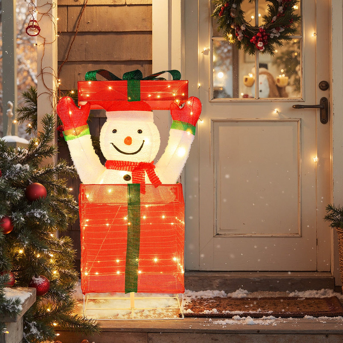 Lighted snowman gift-box decoration with red boxes, green ribbon, and warm lights on Tampa Home & Garden Store