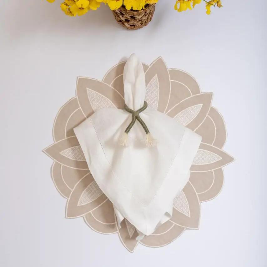 Beige linen flower placemat by Talah Home, handcrafted in Brazil with a round petal motif on Tampa Home & Garden Store