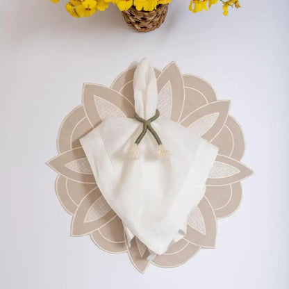 Beige linen flower placemat by Talah Home, handcrafted in Brazil with a round petal motif on Tampa Home & Garden Store