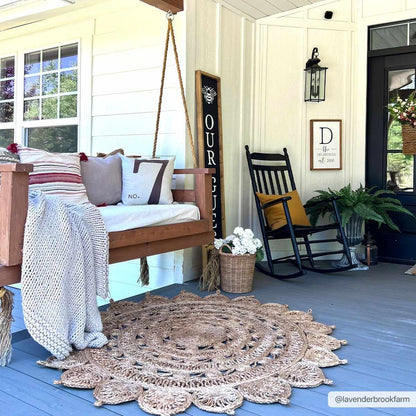 Longville round jute rug by Boutique Rugs in natural beige with crochet edge on a porch on Tampa Home & Garden Store