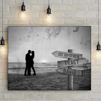 Monochrome Sunset Couple Sign canvas with silhouette of a couple on a beach beside a signpost on Tampa Home & Garden Store