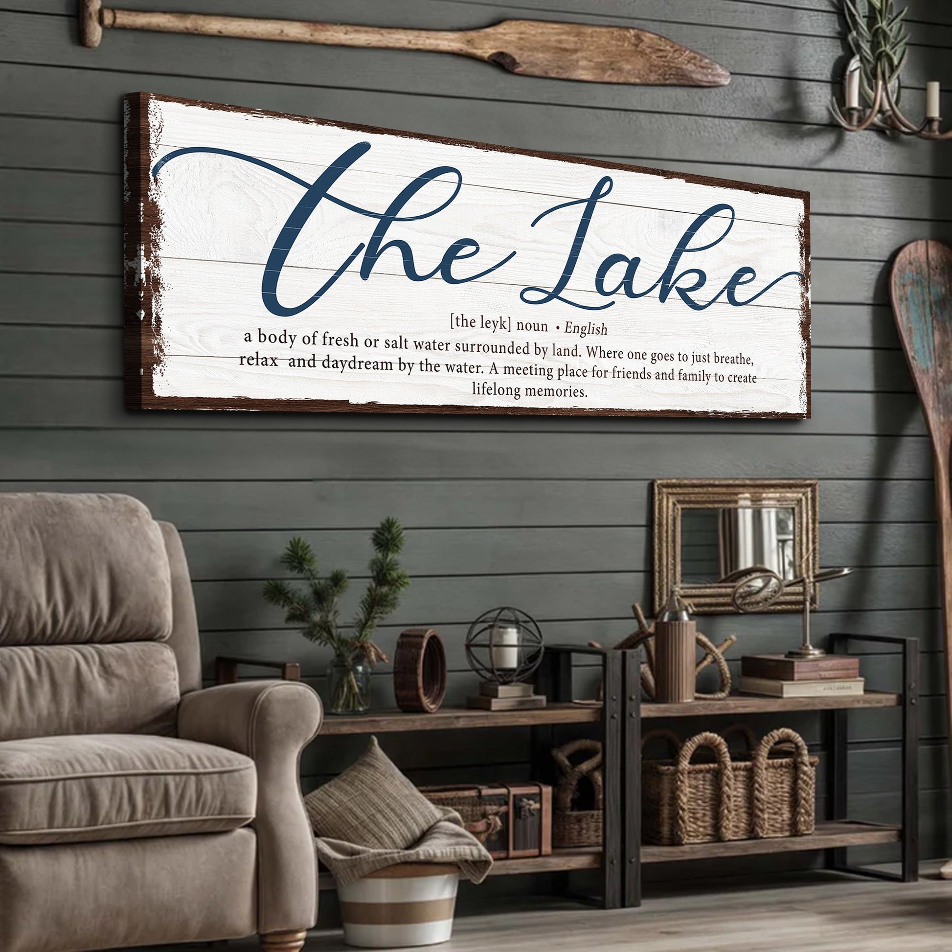 Canvas sign The Lake with blue cursive lettering and distressed brown edges on white wood on Tampa Home & Garden Store