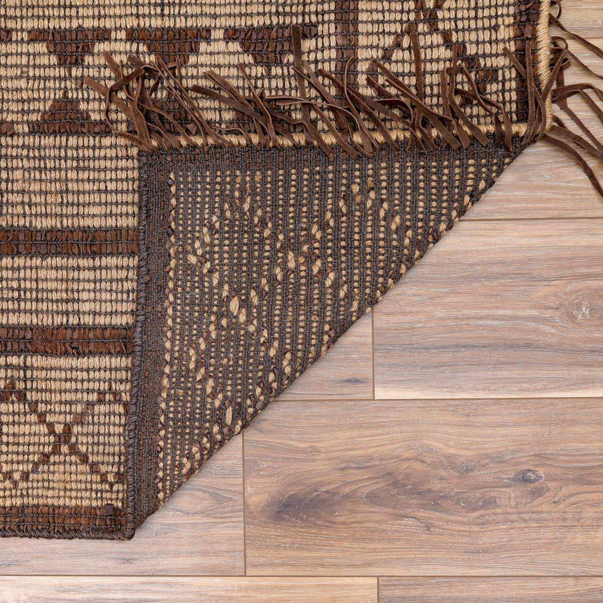 Maia Jute & Leather Area Rug in brown and beige tones with leather fringe by Boutique Rugs on Tampa Home & Garden Store
