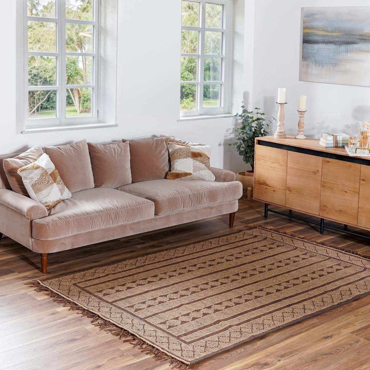Maia Jute & Leather Area Rug in natural beige with brown striped border and fringed edges on Tampa Home & Garden Store