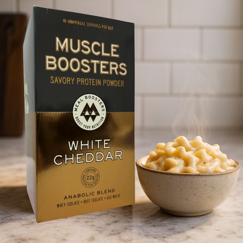 Muscle Boosters White Cheddar protein powder box beside bowl of cheese sauce by Meal Boosters on Tampa Home & Garden Store