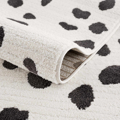 Tariffville Dalmatian Rug cream background with bold black spots, plush shag pile on Tampa Home & Garden Store