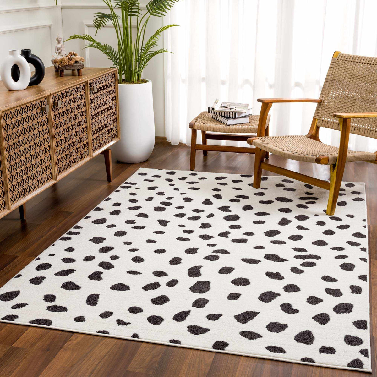 Tariffville Dalmatian Rug by Boutique Rugs, white field with dark spots in a living room on Tampa Home & Garden Store