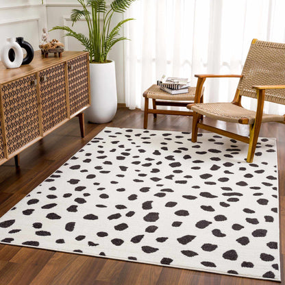 Tariffville Dalmatian Rug by Boutique Rugs, white field with dark spots in a living room on Tampa Home & Garden Store