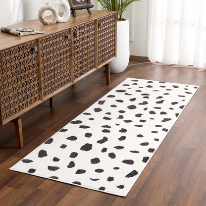 Tariffville Dalmatian Rug by Boutique Rugs, white with black spots in a modern living room on Tampa Home & Garden Store