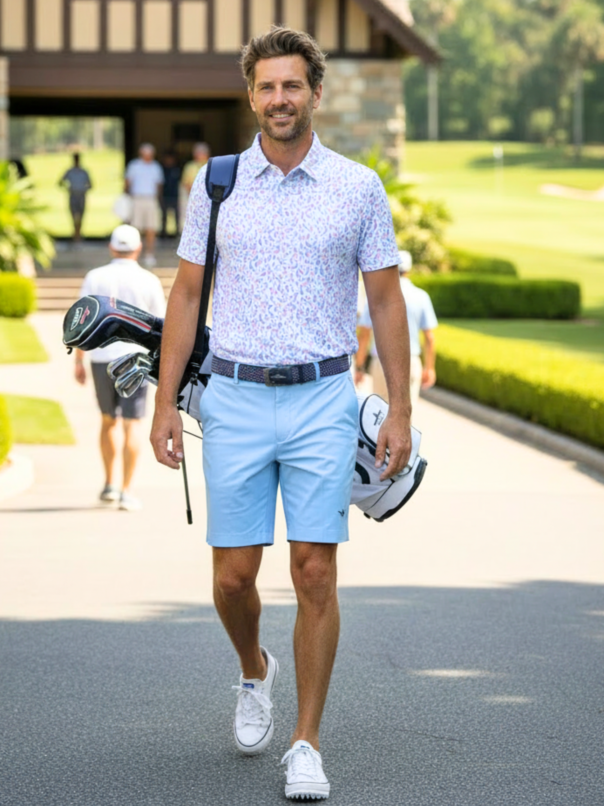 Mermaid Polo by White Water Life; light blue floral polo worn by a man with a golf bag on Tampa Home & Garden Store