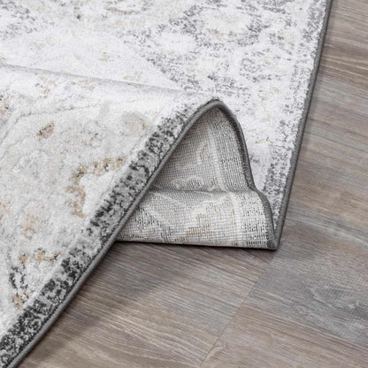 Minoa Area Rug by Boutique Rugs, distressed grey ivory pattern on wood floor on Tampa Home & Garden Store