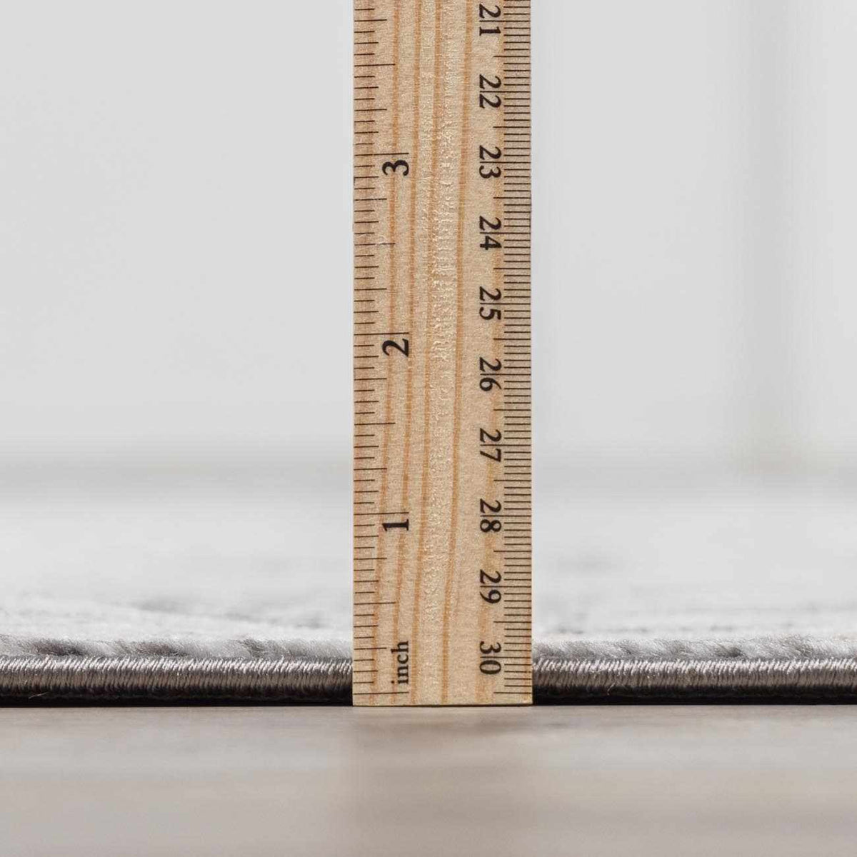 Minoa Area Rug gray textured edge from Boutique Rugs, closeup with ruler for scale on Tampa Home & Garden Store