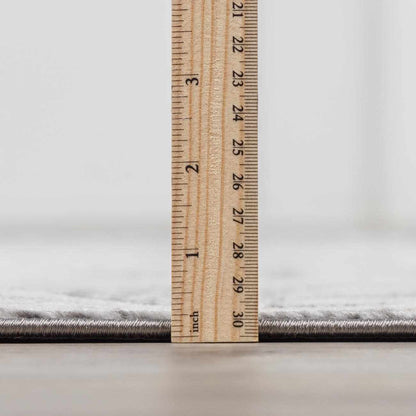 Minoa Area Rug gray textured edge from Boutique Rugs, closeup with ruler for scale on Tampa Home & Garden Store