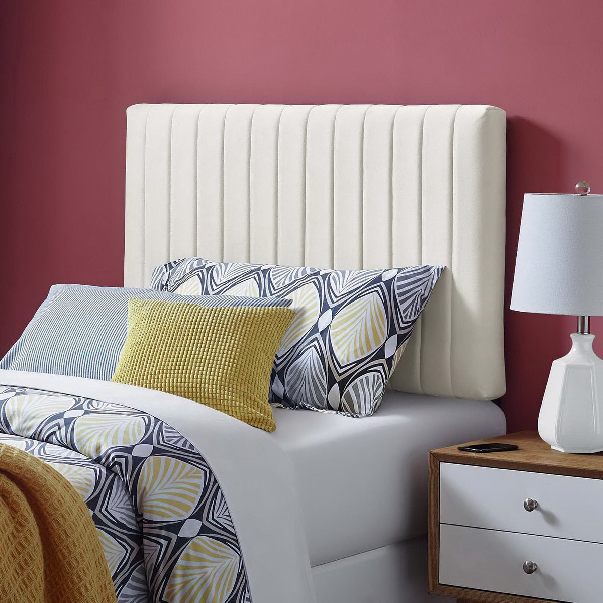 Keira Performance Velvet Headboard white with vertical channel tufting on a bed against burgundy wall on Tampa Home & Garden Store