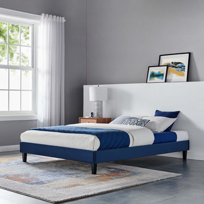 Blue velvet platform bed by Modway with white bedding and navy bed skirts in a modern bedroom on Tampa Home & Garden Store
