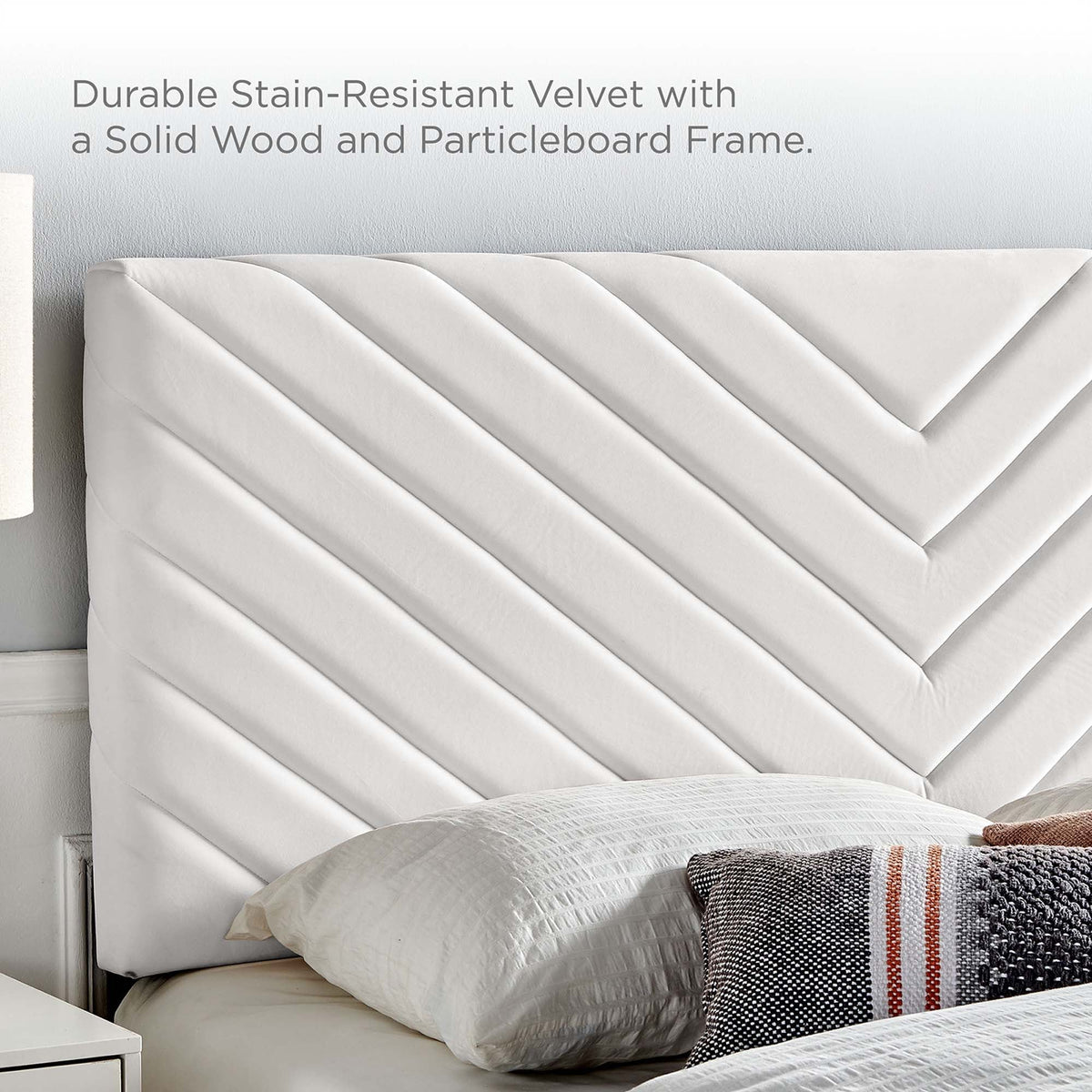 Roxanne tapered wood-leg queen platform bed with a white quilted velvet headboard on Tampa Home & Garden Store