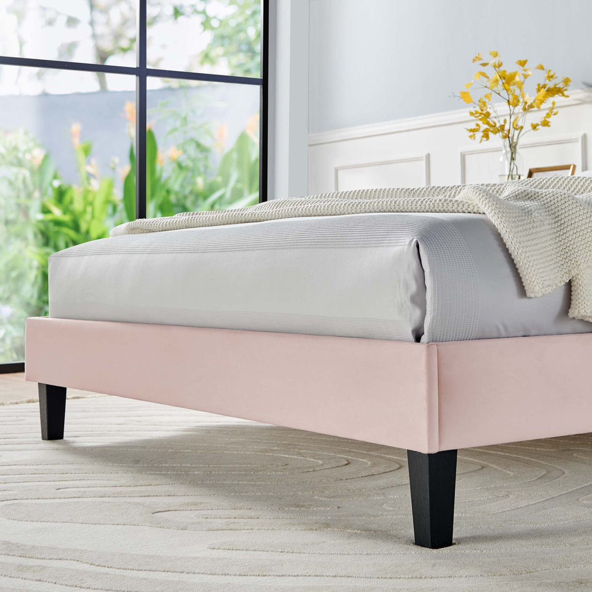 Daisy tapered wood-leg velvet queen platform bed with pink bed skirt and gray bedding on Tampa Home & Garden Store