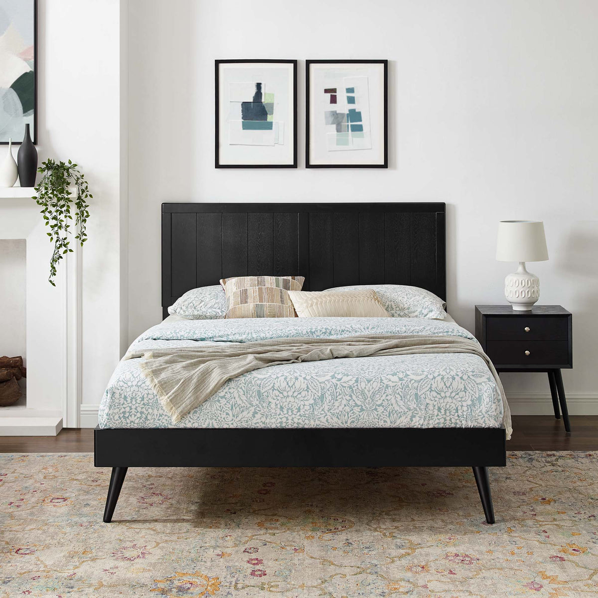 Alana wood platform bed with black finish and splayed legs; two framed prints above headboard on Tampa Home & Garden Store