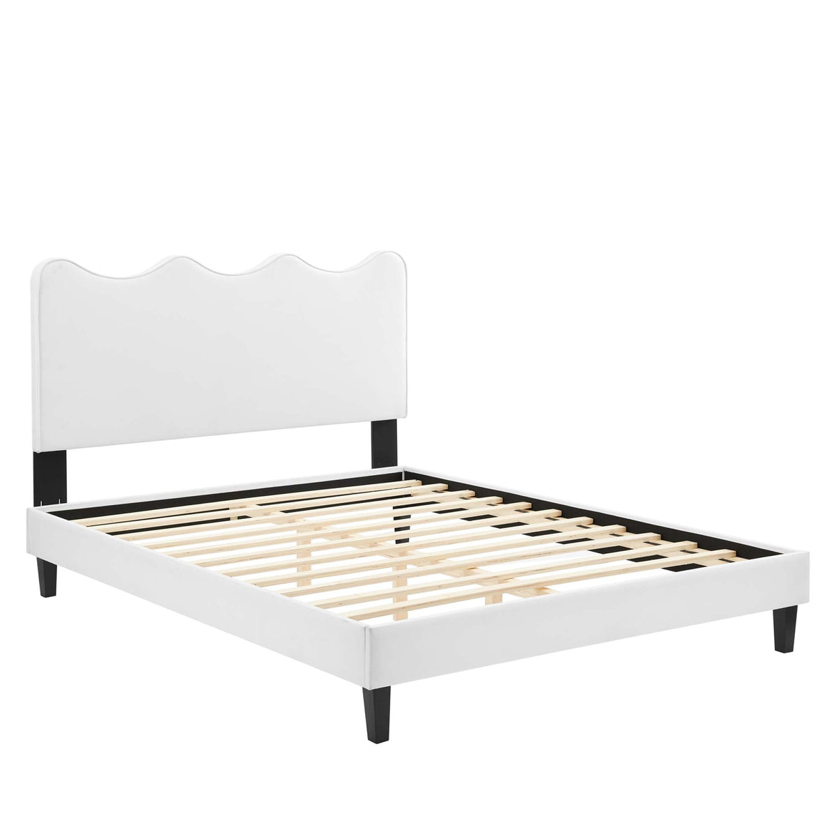 Queen platform bed with white upholstered headboard featuring scalloped top and black legs on Tampa Home & Garden Store